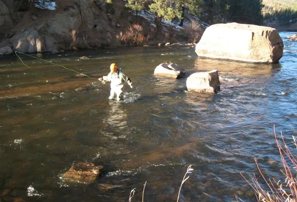 Kollin wading - Kollin keeps his knees upstream as he crosses the river in search of more fishy water.